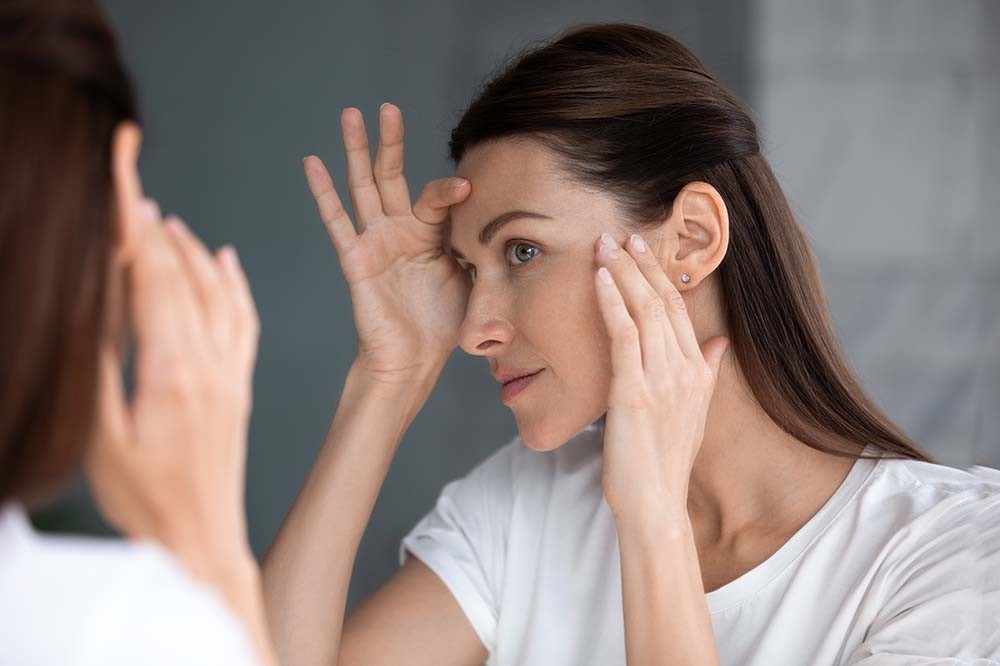 woman looking in mirror